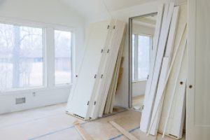 Interior wooden stacker door installation,apartment building, a wait installation for preparation of interior in new home