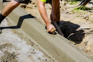 The process of construction of the sidewalk, the installation of under construction a concrete curb